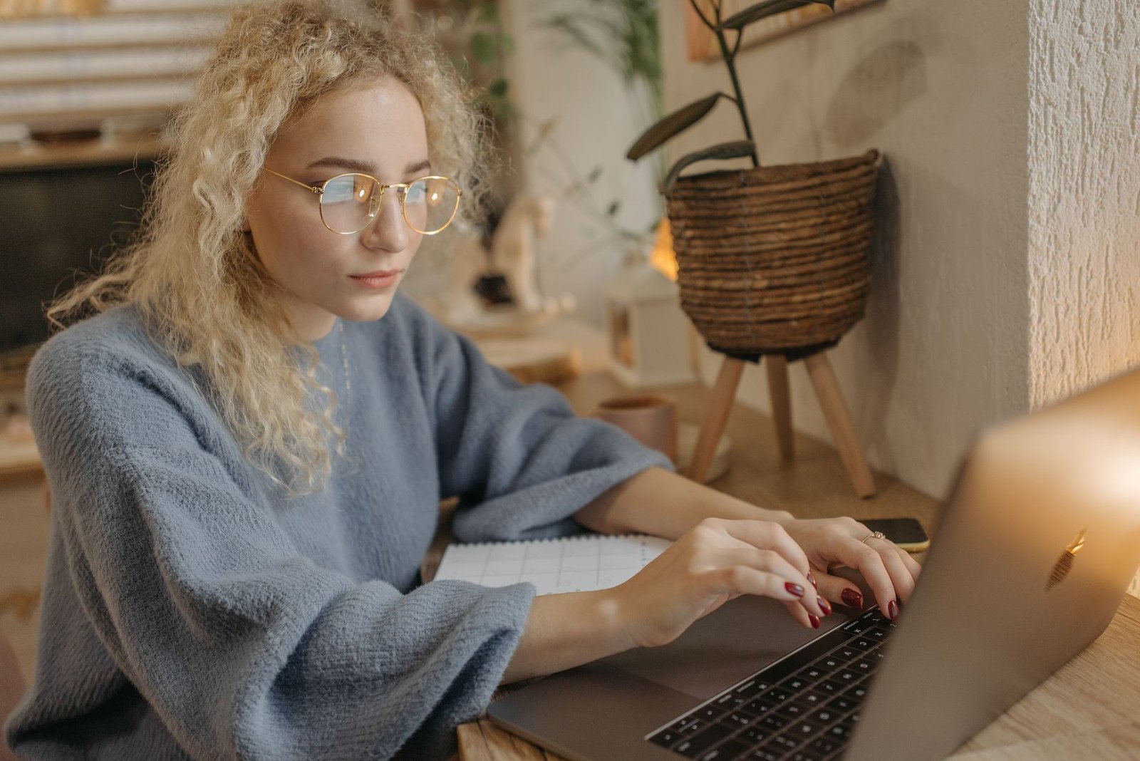 A writer drafting an article on a laptop at a home desk