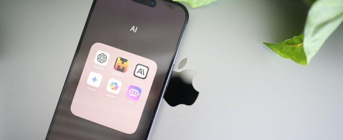 A phone showing a folder of AI apps used to compare and pick the best AI subscription 2026