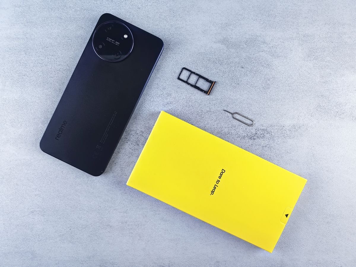 A smartphone with its SIM tray and ejector tool, ready to switch carriers