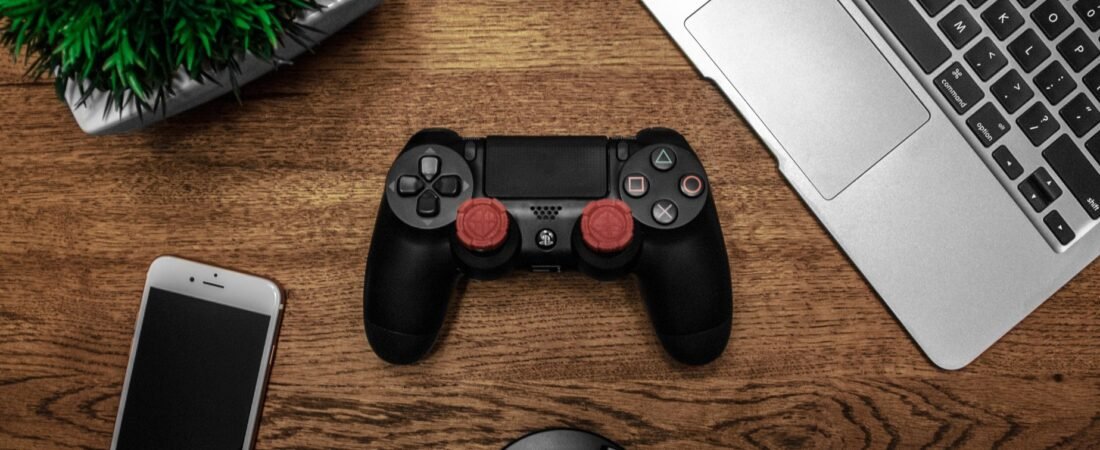 Phones and laptops getting more expensive in 2026, shown alongside a games console on a desk.