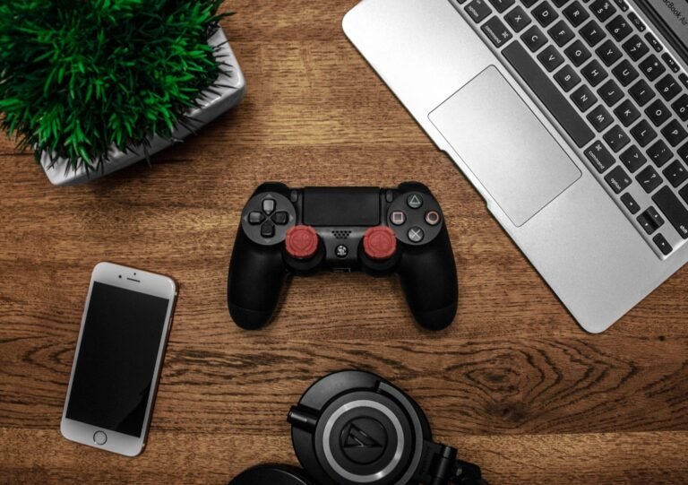 Phones and laptops getting more expensive in 2026, shown alongside a games console on a desk.