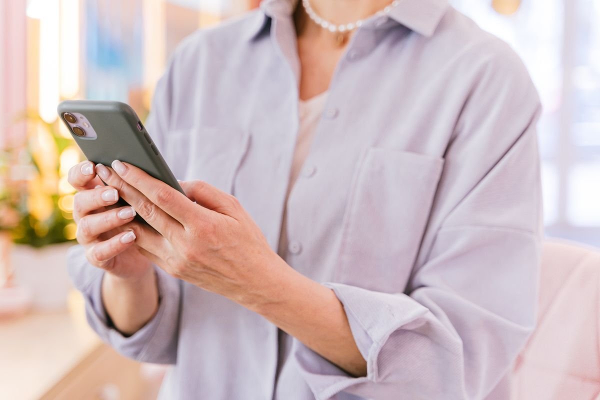 Using a smartphone privately in a bright modern room