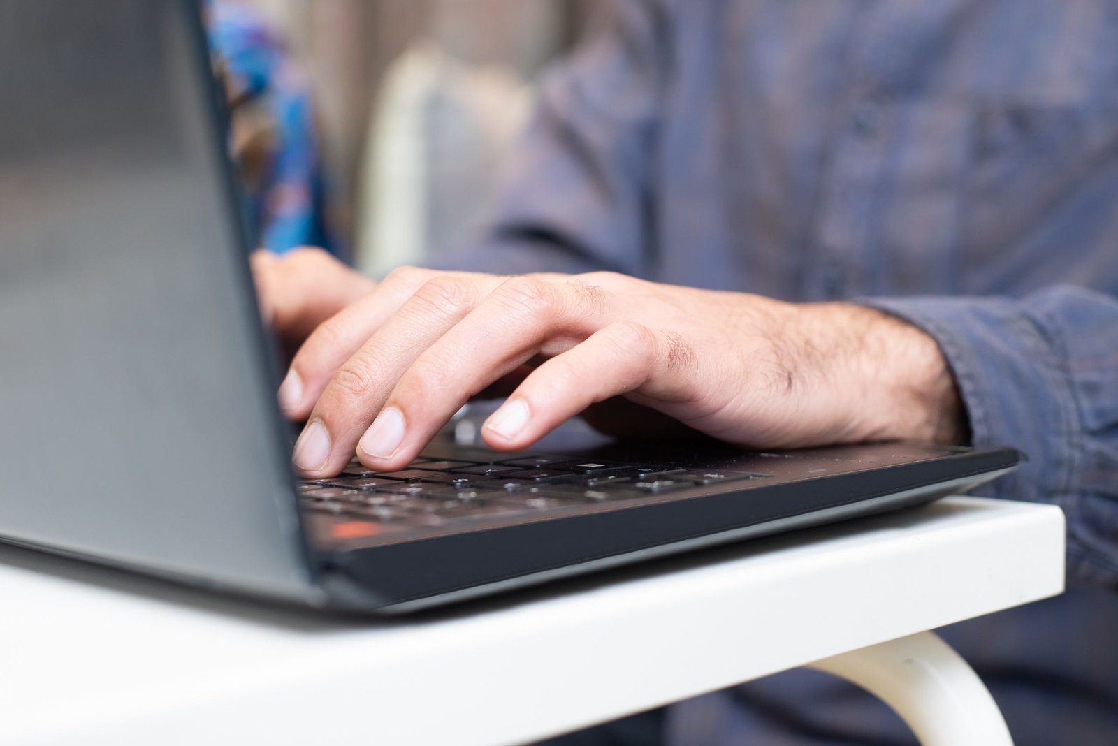 Person using a Windows laptop to check the Memory tab in Task Manager for slots used and form factor
