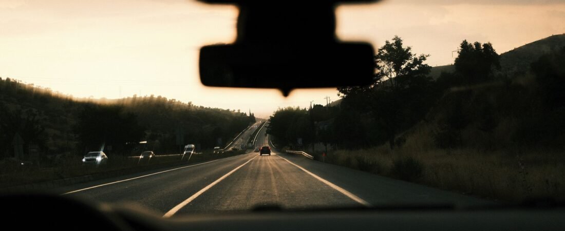 best dash cam 2026 mounted behind a windshield on an open sunny road