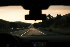 best dash cam 2026 mounted behind a windshield on an open sunny road