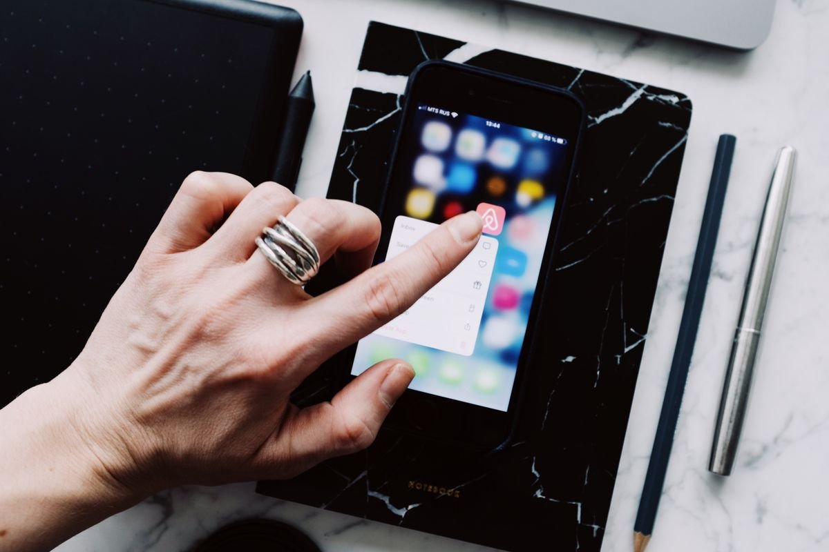 Tapping through a smartphone menu to delete saved data