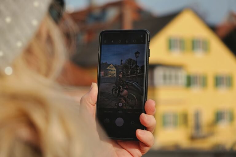 Holding up a phone outdoors to edit and share a bright photo