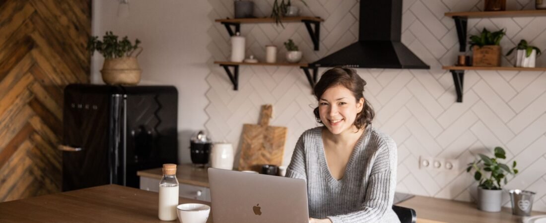 Person relaxed at a laptop managing a home budget spreadsheet