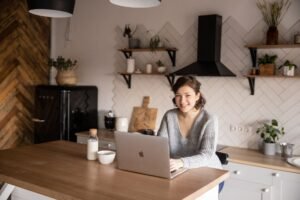 Person relaxed at a laptop managing a home budget spreadsheet