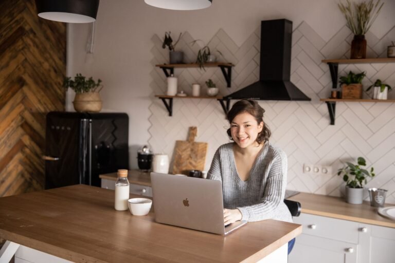 Person relaxed at a laptop managing a home budget spreadsheet