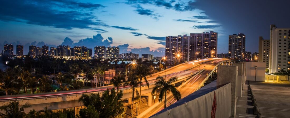 gta 6 standard vs ultimate edition choice illustrated by a neon Miami-style skyline at dusk
