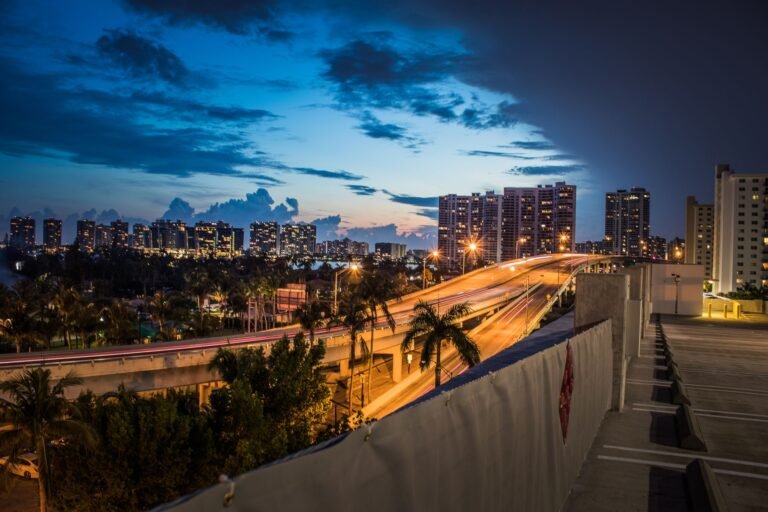gta 6 standard vs ultimate edition choice illustrated by a neon Miami-style skyline at dusk