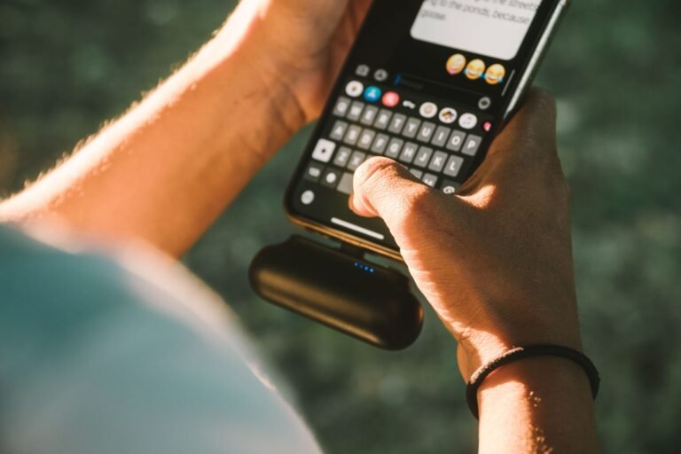 How to choose a power bank: a person charging a phone with a portable power bank on the go