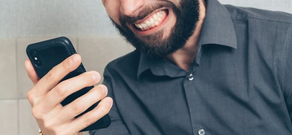 How to stop spam texts: person frustrated by a flood of spam messages on his phone