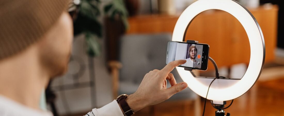 Creator setting up a phone on a ring light to record an Instagram trial reel