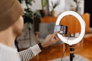 Creator setting up a phone on a ring light to record an Instagram trial reel