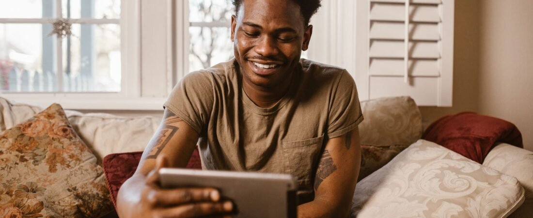 iPad vs budget Android tablet comparison, a person relaxing with a tablet at home
