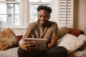 iPad vs budget Android tablet comparison, a person relaxing with a tablet at home