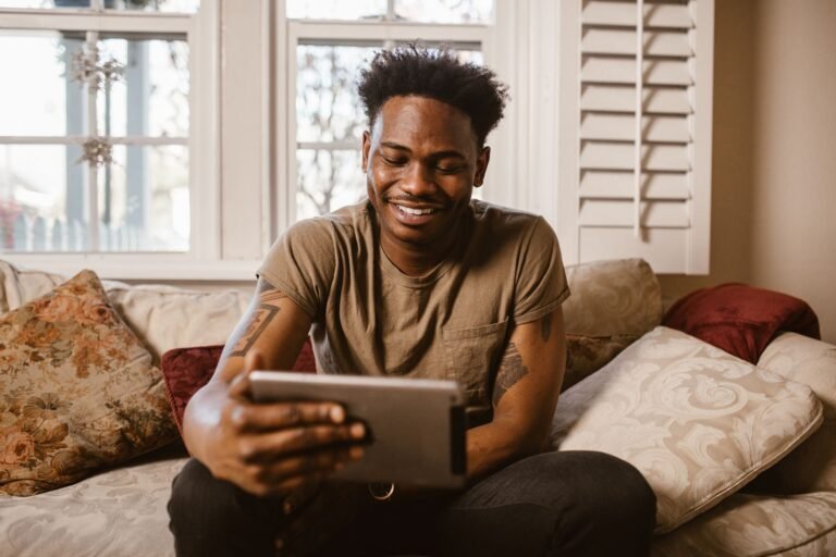 iPad vs budget Android tablet comparison, a person relaxing with a tablet at home