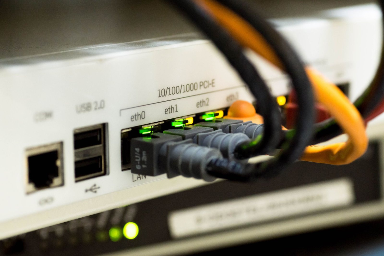 Ethernet cables plugged into a router, showing wired backhaul between mesh nodes