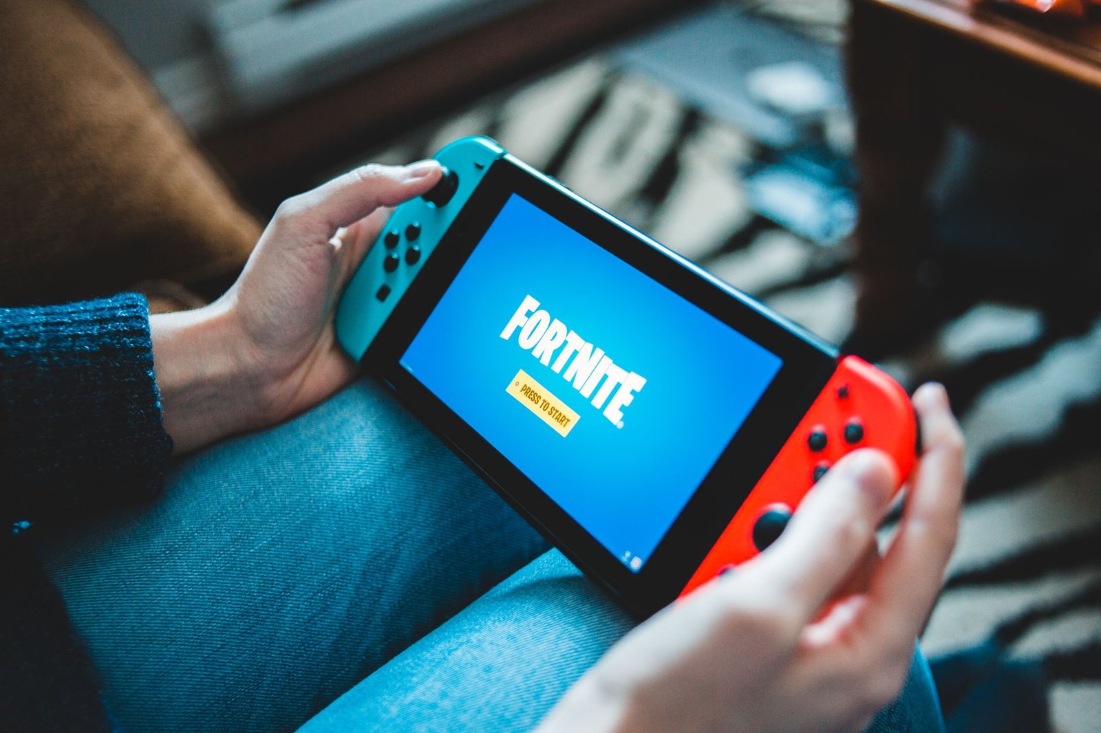 Playing a Nintendo Switch on the couch at home