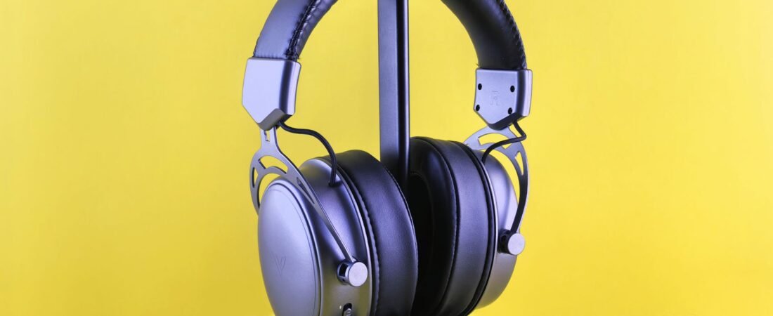 Budget over-ear noise cancelling headphones under $100 on a bright colorful surface