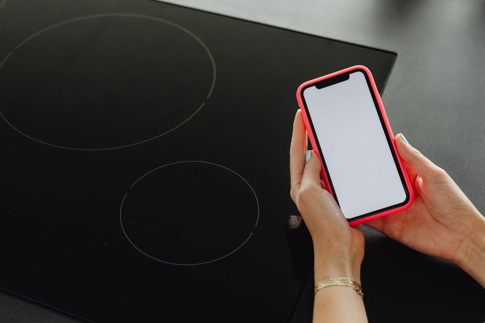 Smartphone showing a parental control app dashboard on a kitchen counter