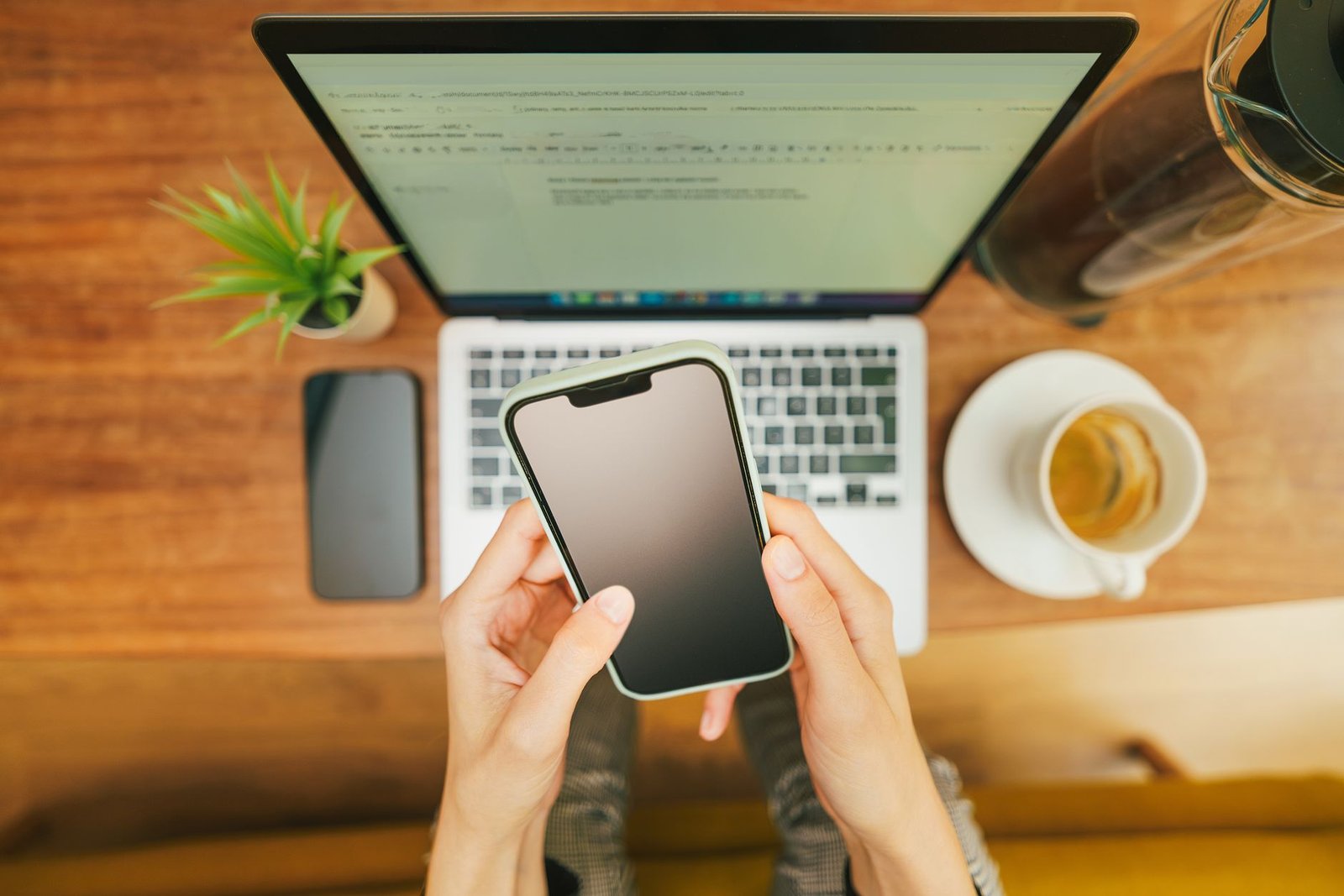 Parent reviewing screen time and app settings on a phone at home