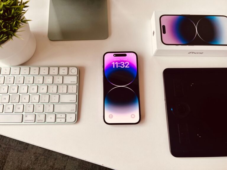 A smartphone set up on a tidy desk beside a keyboard, ready to run automations