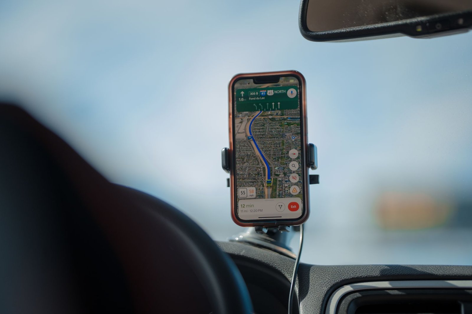 A phone on a hot car dashboard, a common cause of phone overheating in summer