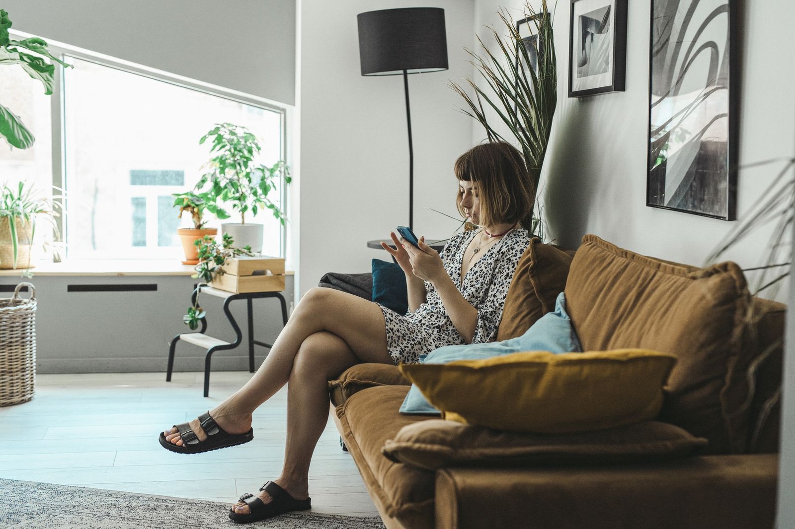 Person on a couch waiting for a video to load on their phone