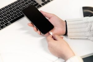 Portable power station buying guide: a mid-size battery unit running a phone, laptop and lamp on a counter