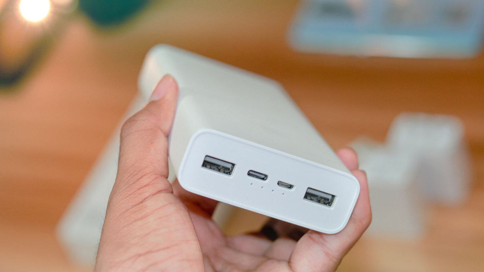 Close-up of a power bank showing its USB output ports and power rating