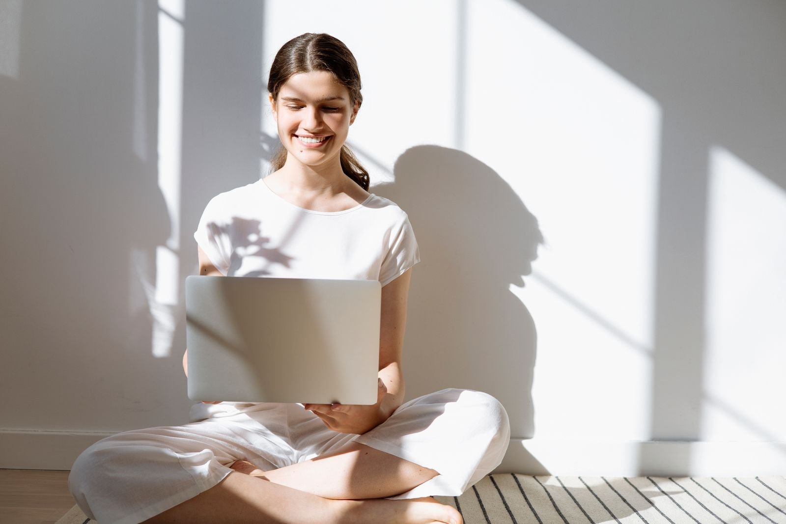 Person smiling while reviewing a video summary on a laptop