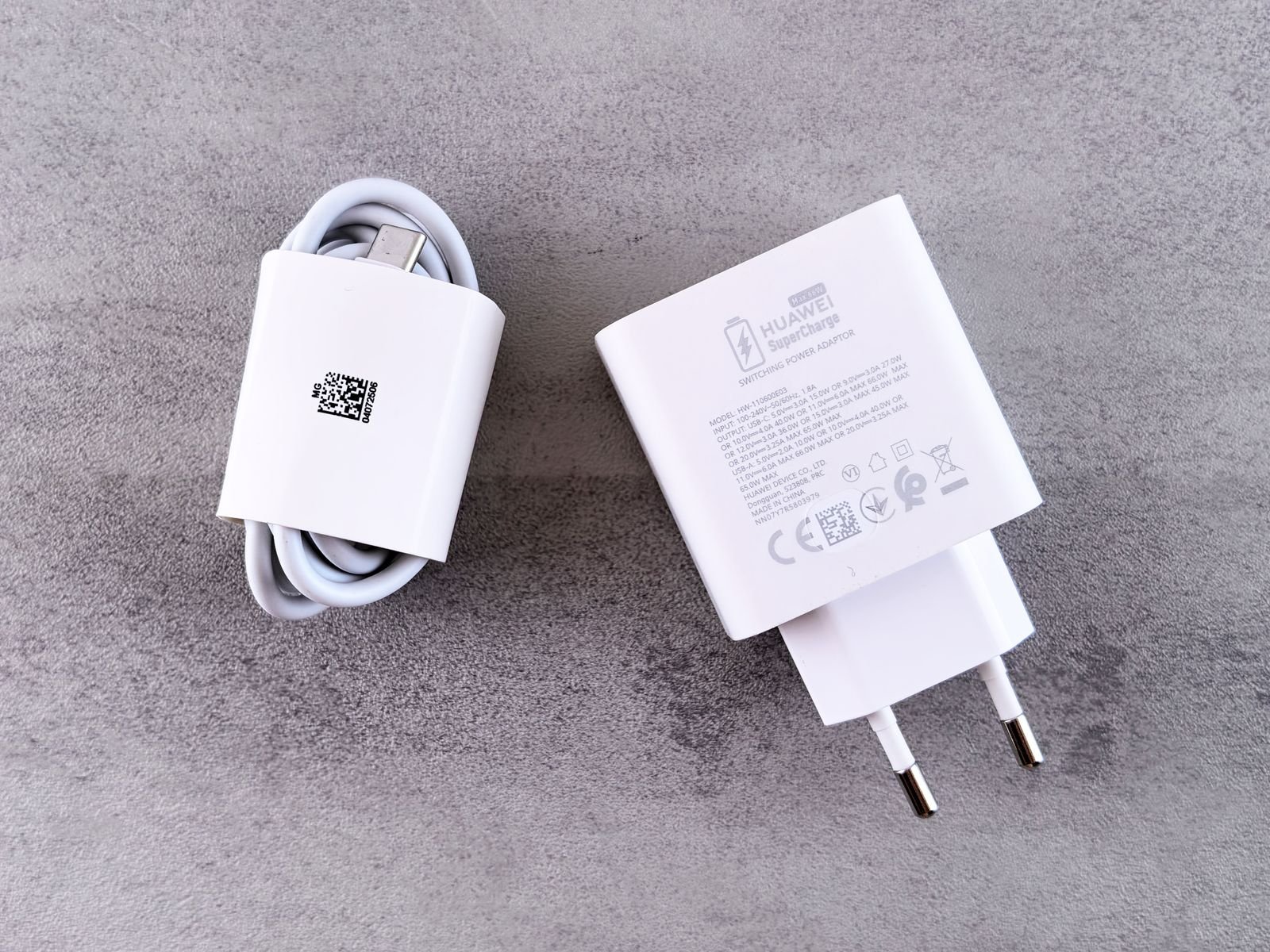 Macro of a USB-C charger output label showing voltage and amperage lines including PD