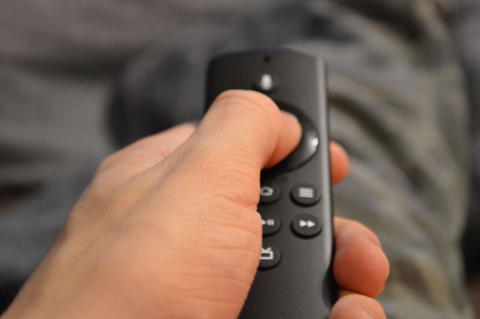 Viewer comparing streaming bundle vs separate subscriptions on a living room TV