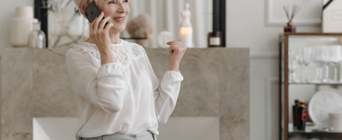 Senior woman smiling during a phone call at home