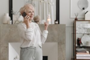 Senior woman smiling during a phone call at home