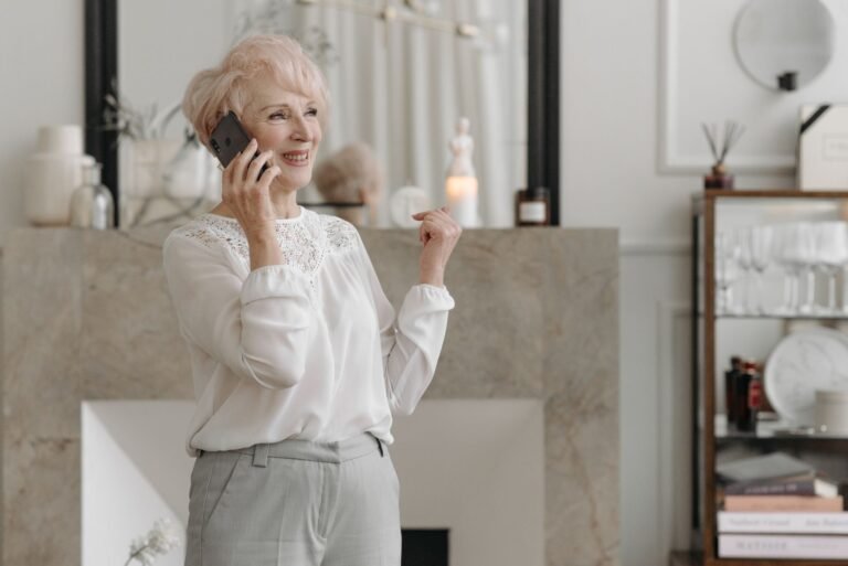 Senior woman smiling during a phone call at home