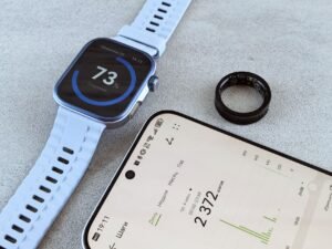 Smart ring vs smartwatch: a smart ring beside a smartwatch on a bright desk