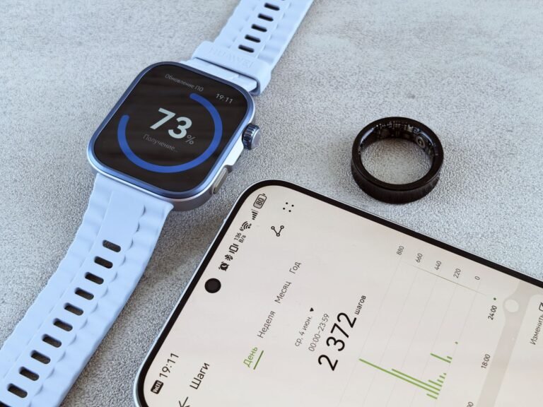 Smart ring vs smartwatch: a smart ring beside a smartwatch on a bright desk