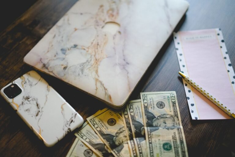 Cheap cell phone plans 2026: a smartphone next to saved cash on a desk.