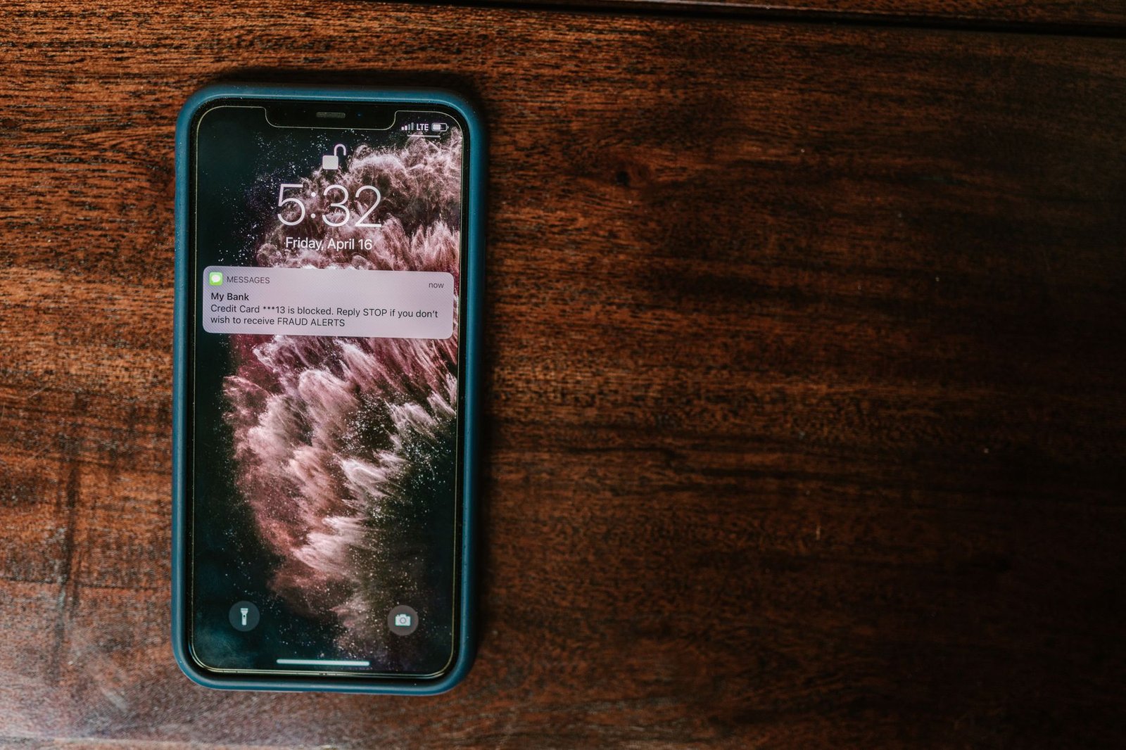 Spam text on a phone lock screen pressuring the reader to reply STOP
