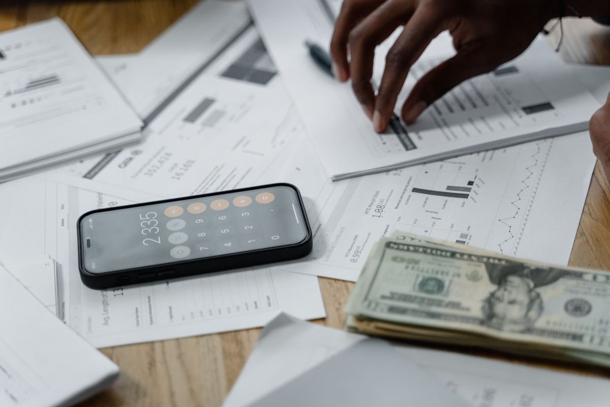 Running the streaming price increase 2026 worksheet with a phone calculator and bills
