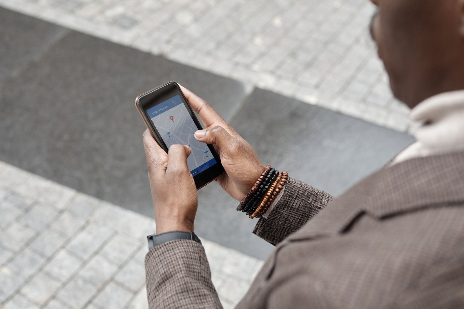 Person using a phone GPS navigation app outdoors in the sun