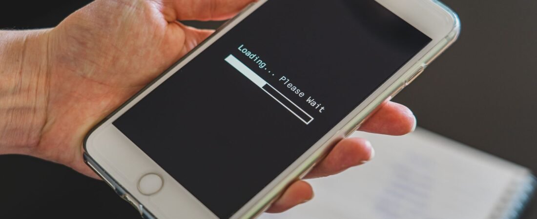 wifi bars vs internet speed shown by a phone stuck on a slow loading screen
