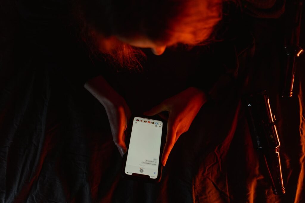 Person watching a video clip on a phone in dim light, wondering if it is real