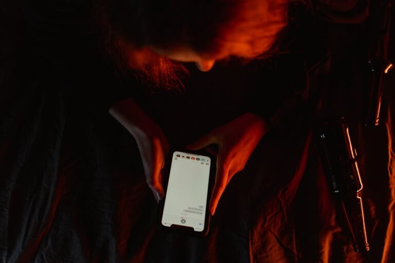 Person watching a video clip on a phone in dim light, wondering if it is real