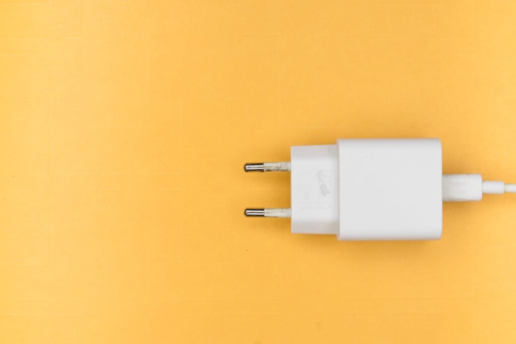 Best GaN charger 2026 pick: a compact white USB-C wall charger on a bright yellow background.