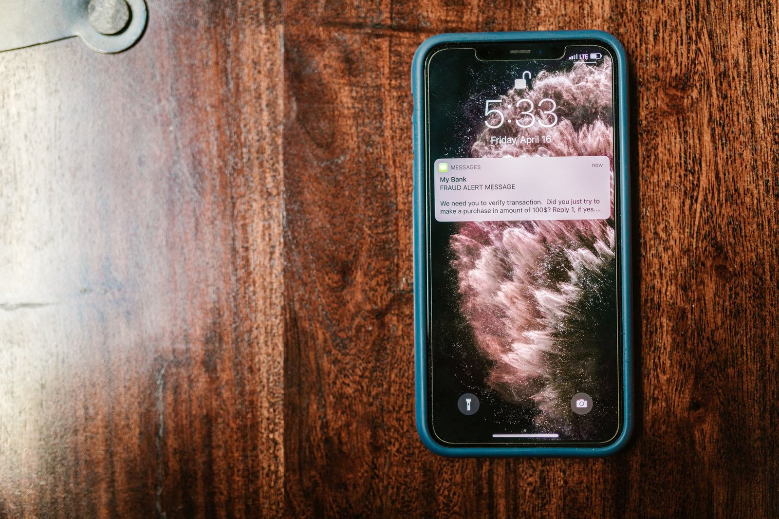 Suspicious fraud alert text message on a smartphone screen